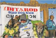 ?? LOREN HOLMES/ANCHORAGE DAILY NEWS VIA THE ASSOCIATED PRESS ?? Ryan Redington poses Tuesday in Nome, Alaska, with his lead dogs, Sven, left, and Ghost after he won the 2023 Iditarod Trail Sled Dog Race.