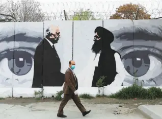 ??  ?? THE IMAGES of Zalmay Khalilzad, U.S. envoy for peace in Afghanista­n, and Mullah Abdul Ghani Baradar, the leader of the Taliban delegation for talks, painted on a wall, in Kabul on April 13, 2020. There are no hard and fast rules on ceasefire. The Americans are talking to the Taliban in Doha while the Taliban kills Americans in Afghanista­n.