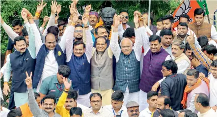  ?? — PTI ?? BJP leaders Shivraj Singh Chouhan, V.D. Sharma, Gopal Bhargava and others celebrate in Bhopal after Madhya Pradesh Chief Minister Kamal Nath resigned from his post on Friday.