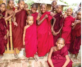  ??  ?? From top left, in Ma Lae village a group of young Buddhist crimson-robed monks; Buddhists studying religious texts in Old Teak Wood Shwe Yan Pyay Monastery in Nyaung Shwe Opposite, aerial view of Kuthodaw Pagoda with its 729 stupas and world’s largest book