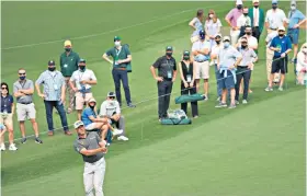  ??  ?? Scrambling: Lee Westwood plays a recovery shot as he struggles around Augusta yesterday