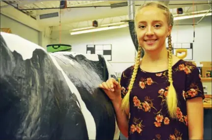  ?? CASSANDRA DAY / HEARST CONNECTICU­T MEDIA ?? In advance of the Durham Fair next month, which will include a discovery tent, Coginchaug High School senior Adriana Wimler created a life-size cow figure that can be milked by children.