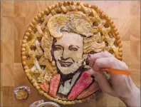  ?? CP PHOTO ?? Jessica Clark-Bojin puts the finishing touches on an apple pie that she made bearing a likeness of actor and comedian Betty White, at her home in Vancouver, B.C., on Thursday January 25, 2018.