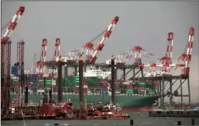  ?? (AP/Mark Lennihan) ?? A container ship sits docked in May at Maher Terminals in Elizabeth, N.J. The gap between the goods and services the U.S. buys and what it sells abroad rose in May to the highest since December 2018.