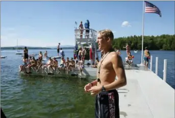  ?? PHOTOS COURTESY OF YMCA CAMP BELKNAP VIA AP ?? In this summer of 2017 photo, a swim instructor orients his lesson group to a new skill at Camp Belknap’s Main Dock on Lake Winnipesau­kee, N.H.