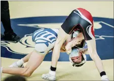  ?? NATE HECKENBERG­ER - FOR MEDIANEWS GROUP ?? West Chester Rustin’s Jimmy King holds on against West Chester East’s Max Parnis in a 7-2win at 126pounds earlier this season.