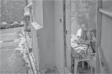  ?? Dennis M. Rivera Pichardo / New York Times ?? Ramon Marrero, 79, has lived inside his brother’s tool shed since Hurricane Maria claimed his home in the shantytown of La Perla in Old San Juan, Puerto Rico. He walks to the post office to charge his cellphone.