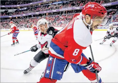  ?? AP PHOTO ?? Arizona Coyotes right wing Michael Grabner, back, and Washington Capitals left wing Alex Ovechkin (8) battle for the puck in the third period of an NHL hockey game, Sunday in Washington.