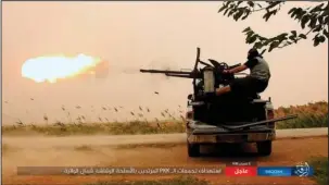  ?? The Associated Press ?? GROWING ROLE: This undated image posted online May 1 by supporters of the Islamic State militant group on an anonymous photo sharing website, purports to show an Islamic State fighter firing his weapon during clashes with U.S.-backed Kurdish-led Syrian...