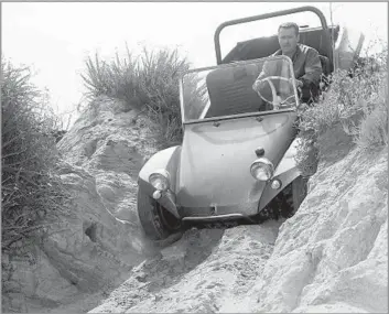  ?? Eric Rickman Enthusiast Network ?? A SANDY SPIN
Bruce Meyers drives one of his Meyers Manx vehicles that made maneuverin­g sand dunes and beaches a real joyride for many. The vehicles became symbols of California’s beach and surf culture.