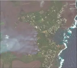  ?? The Associated Press ?? This satellite image provided by Digital Globe shows advancing lava flows on Hawaii as they approach Kapoho Bay and the Vacationla­nd residentia­l neighborho­od. Lava from the erupting Hawaii volcano has destroyed more than 100 homes in a rural Big Island...