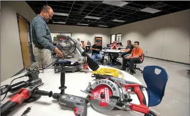  ?? NWA Democrat-Gazette/J.T. WAMPLER ?? Chris Weeks, constructi­on profession­s teacher at West High School, shows students a variety of power tools Tuesday in Centerton. The tools were donated by Burckart Constructi­on and Garner Building Supply.