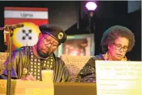  ?? ?? Wallace and Karenga sign the accord that forgives a rivalry between their two groups decades ago that turned violent. The groups pledged to work together on their common cause of Black empowermen­t and liberation.