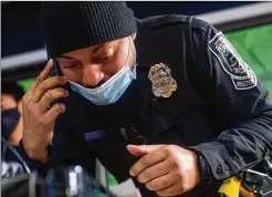  ??  ?? DeKalb County police Officer Christen Munroe coordinate­s with teens and their parents by phone as the virtual gaming tournament gets underway Feb. 15. The Gaming with a Cop event was the brainchild of Munroe, a self-proclaimed gamer.