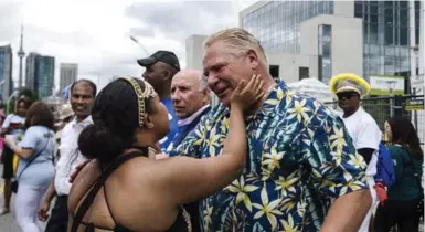  ?? CHRISTOPHE­R KATSAROV/THE CANADIAN PRESS ?? A parade participan­t greets Doug Ford during the Grand Parade at the Caribbean Carnival in Toronto in August. Mayor John Tory looks unbeatable in 2018, Bob Hepburn writes, but conditions could be perfect for a Ford mayoralty in 2022.