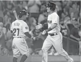  ??  ?? Astros third baseman Alex Bregman (right) celebrates his home run with Jose Altuve (27) during the eighth inning Saturday night.