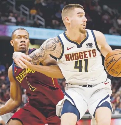  ?? Tony Dejak, The Associated Press ?? The Nuggets’ Juan Hernangome­z, driving around the Cleveland Cavaliers’ Rodney Hood, scored a gamehigh 23 points in 29 minutes Thursday night after sitting out Wednesday night’s overtime thriller in Chicago.