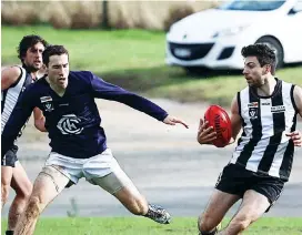  ??  ?? Poowong’s Chris Doria evades his Catani opponent. The Magpies put in a gallant effort, but went down by 17-points; Photograph: Jeff Tull.