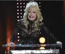  ?? PHOTO BY CHRIS PIZZELLO/INVISION/AP ?? Dolly Parton accepts her award at MusiCares Person of the Year on Friday, at the Los Angeles Convention Center.