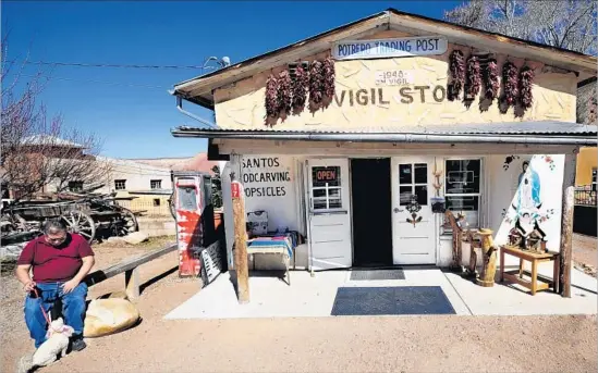  ?? Robert Alexander Getty Images ?? RED CHILES, beloved in the northern part of New Mexico, hang in ristras at Potrero Trading Post in the hot pepper hub of Chimayó. The store sells powdered chile.