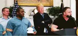  ?? Doug Mills / New York Times ?? Ron Davis, right, and other steel workers gathered in the Oval Office as President Donald Trump signed an order imposing new tariffs.