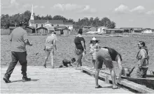  ?? ARDELLE REYNOLDS • CAPE BRETON POST ?? Potlotek Fisheries hosted a community cleanup along the shoreline of the Bras d'Or Lakes for National Indigenous Peoples Day. Chapel Island, the sacred meeting site of the Saint Anne's Mission is pictured in the background.