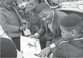  ??  ?? Christian Freeman, from left, Tykese Kirkwood-Welch, Dameion Cowans and Tyrell Kirkwood read together during Fatherhood Fridays at Buena Vista Elementary.