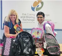  ??  ?? Upon delivering the haul from his Sharing in Student Success School Supply Drive, Yasir Naqvi, MPP Ottawa Centre, playfully sports a Disney Princess backpack as he poses with Cindy Smith, executive director of the Caring and Sharing Exchange.