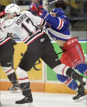  ?? DAVID BEBEE, WATERLOO REGION RECORD ?? Owen Sound Attack’s Trent Bourque fends off Nick McHugh of the Kitchener Rangers in March.