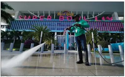  ?? (AP/Chris Carlson) ?? Moisr Altidor pressure washes a sidewalk outside Hard Rock Stadium in Miami Gardens, Fla., in preparatio­n for Sunday’s Super Bowl LIV between the Kansas City Chiefs and the San Francisco 49ers.