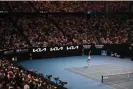  ?? Anthony Wallace/AFP/Getty Images ?? Novak Djokovic serves against Andrey Rublev in a packed Rod Laver Arena. Photograph: