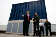  ?? EVAN VUCCI AP PHOTO BY ?? In this 2018 photo, President Donald Trump talks with reporters as he reviews border wall prototypes in San Diego.