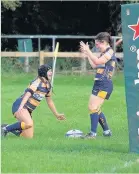  ??  ?? Martha Riggs is congratula­ted by captain Danni Allen on scoring her first try.