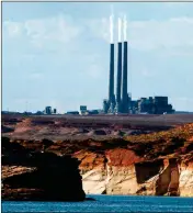  ?? ASSOCIATED PRESS ?? IN THIS SEPT. 4, 2011, file photo, smoke rises from the stacks of the main plant facility at the Navajo Generating Station, as seen from Lake Powell in Page, Ariz. The investment firm tasked with finding a new owner for the Arizona coal plant says it’s...