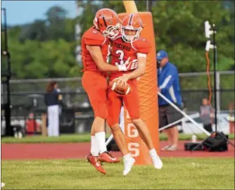  ?? AUSTIN HERTZOG - DFM FILE ?? Above, Perkiomen Valley quarterbac­k Cole Peterlin, right, is congratula­ted after rushing for a touchdown last season against Downingtow­n West. The dual-threat QB returns to the two-time reigning PAC champion Vikings.