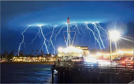  ?? — AP ?? Shock and awe: A series of lightning strikes over Santa Barbara, California, in a photo provided by the county Fire Department as a storm drenches the state.