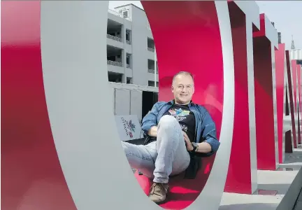  ?? PHOTOS: JULIE OLIVER ?? Ottawa 2017 executive director Guy Laflamme takes a load off at selfie central in Inspiratio­n Village on York Street in the ByWard Market, which is preparing to open Saturday. The site, which will showcase Canada in a succession of cargo containers,...