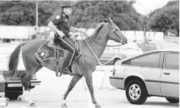  ?? STAFF FILE PHOTO ?? Police officers used their own horses in 1988 when the Broward County Fair took place at Gulfstream Park.