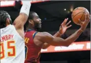  ?? JOHN AMIS — ASSOCIATED PRESS ?? Alec Burks shoots as Hawks forward DeAndre’ Bembry defends during the first half Dec. 29 in Atlanta.