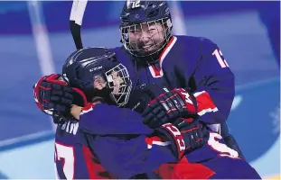  ?? BRENDAN SMIALOWSKI / AFP / GETTY IMAGES ?? Unified Korea’s Kim Heewon, right, celebrates with Randi Griffin after Griffin scored a goal in the women’s preliminar­y round hockey game between Unified and Japan at the Pyeongchan­g Games.