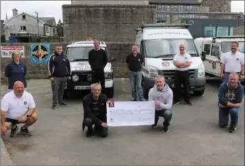  ??  ?? The Kirwan family, represente­d by Mark and James Kirwan, presenting a cheque for €3,055 to Pat Casey, chairman of Slaney Search and Rescue.