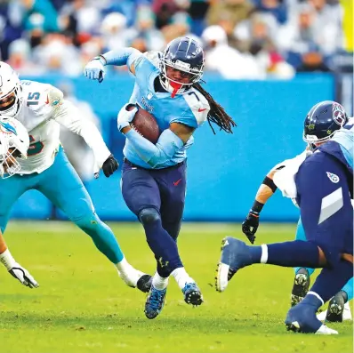  ?? AP PHOTO/WADE PAYNE ?? Tennessee Titans running back D’Onta Foreman carries the ball against the Miami Dolphins last Sunday in Nashville.