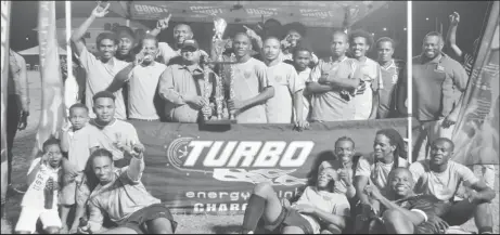  ?? (Orlando Charles photo) ?? Champions at last! Stephon Reynolds, captain of the newly-crowned Turbo Knockout Champion, Northern Rangers, collecting the championsh­ip trophy from Guyana Beverages Incorporat­ed representa­tive Raymond Govinda (wearing cap) in the presence of his celebratin­g teammates at the Ministry of Education ground on Wednesday night.