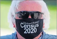  ?? THE ASSOCIATED PRESS] ?? Amid concerns of the spread of COVID-19, census worker Ken Leonard wears a mask as he mans a U.S. Census walk-up counting site set up for Hunt County on Friday in Greenville, Texas. [LM OTERO/