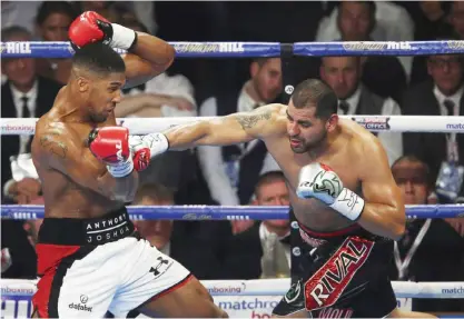  ?? — AP ?? MANCHESTER: Britain’s IBF Heavyweigh­t champion Anthony Joshua, left, fights American Eric Molina in Manchester, England, Saturday.