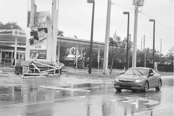  ??  ?? A gas station sign lays destroyed after Hurricane Irma blew though Fort Lauderdale, Florida, September 10. The combined economic cost of Hurricanes Harvey and Irma could reach US$290 billion, equivalent to 1.5 per cent of the US gross domestic product,...