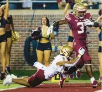  ?? GARY MCCULLOUGH/AP ?? Florida State running back Trey Benson (3) returns the opening kickoff 93 yards for a touchdown, escaping Boston College’s Lewis Bond (11) on Saturday night.