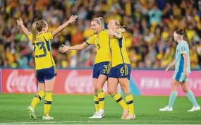  ?? Justin Setterfiel­d/Getty Images ?? Sweden’s Magdalena Eriksson and Linda Sembrant celebrate with Elin Rubensson after winning the FIFA Women’s World Cup third-place match against Australia at Brisbane Stadium on Saturday.