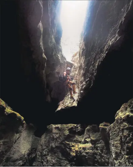  ?? PAM LEBLANC / AMERICAN-STATESMAN ?? Fernando Garcia rappels to the mouth of Gorman Creek Crevice Cave at Colorado Bend State Park.