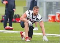  ?? AP Photo/Tony Gutierrez ?? n Houston Texans defensive end J.J. Watt stretches at the start of a morning practice Monday at the Dallas Cowboys training facility in Frisco, Texas. An exhibition game in the Texans’ stadium Thursday might be moved to the home of the Cowboys.